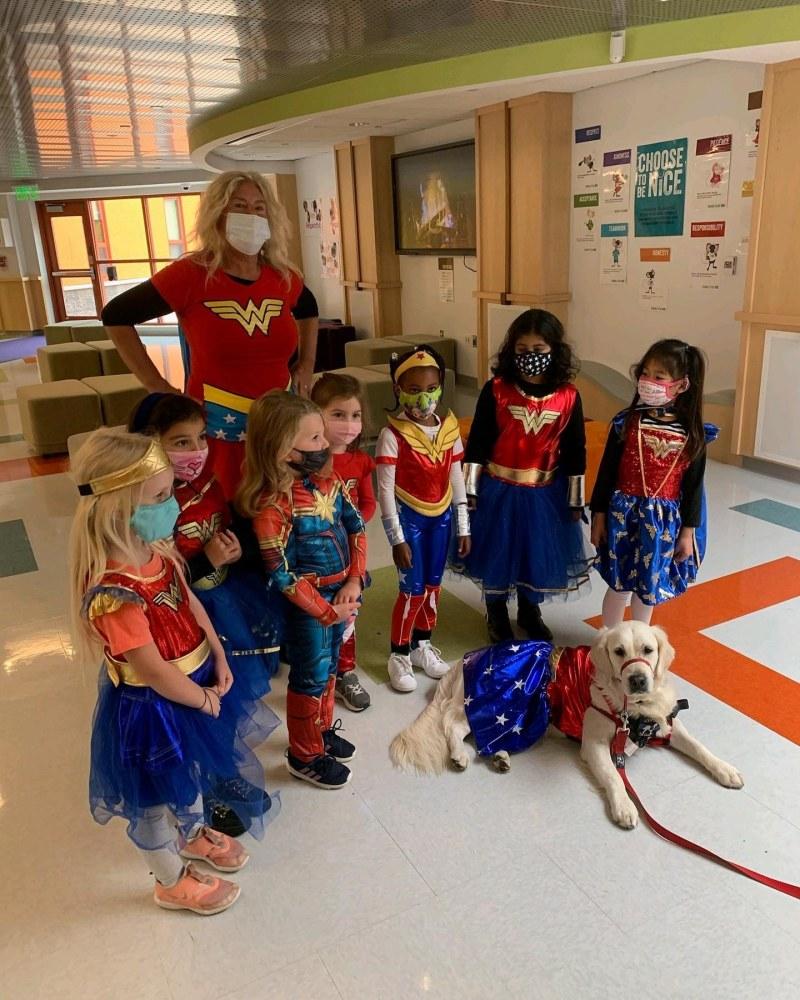 ruby in costume with kids at a school