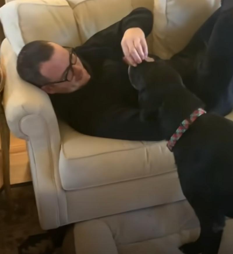 dad petting turbo from the couch