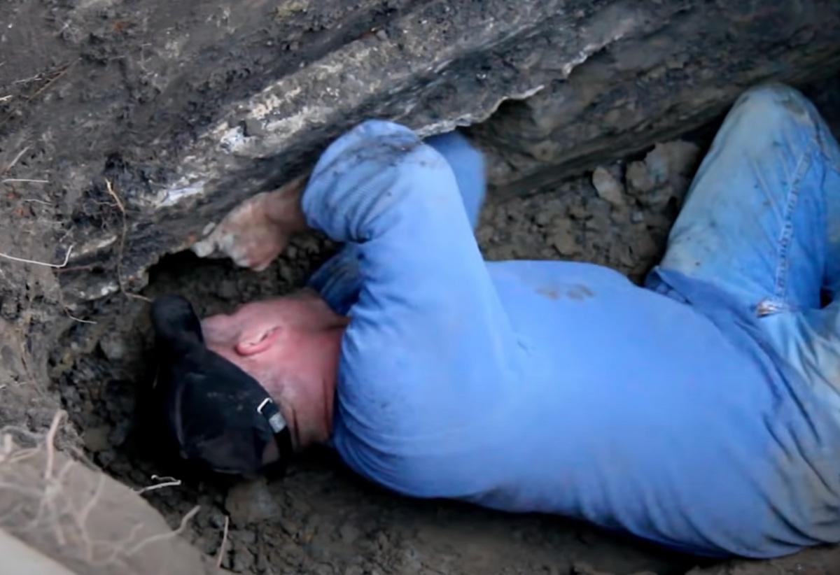 man digging with bare hands