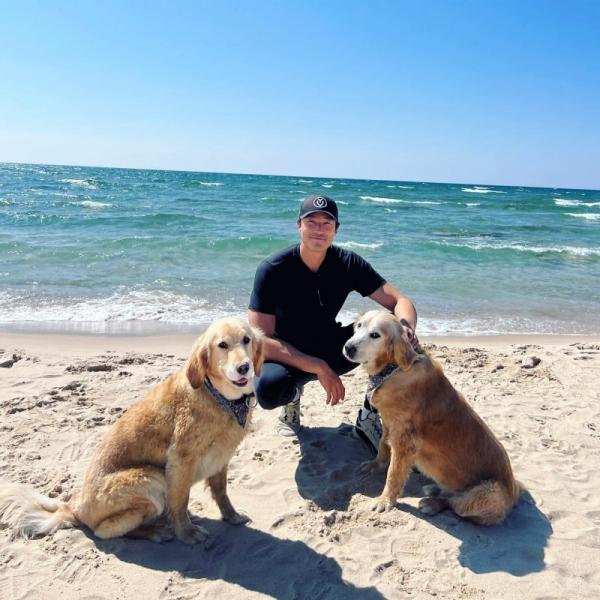 henney with his two dogs at the beach