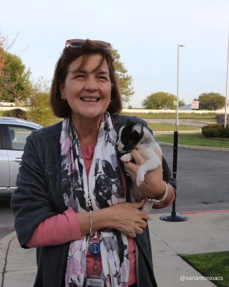 puppy held by woman