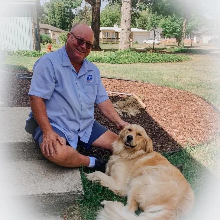 dog and mailman smiling