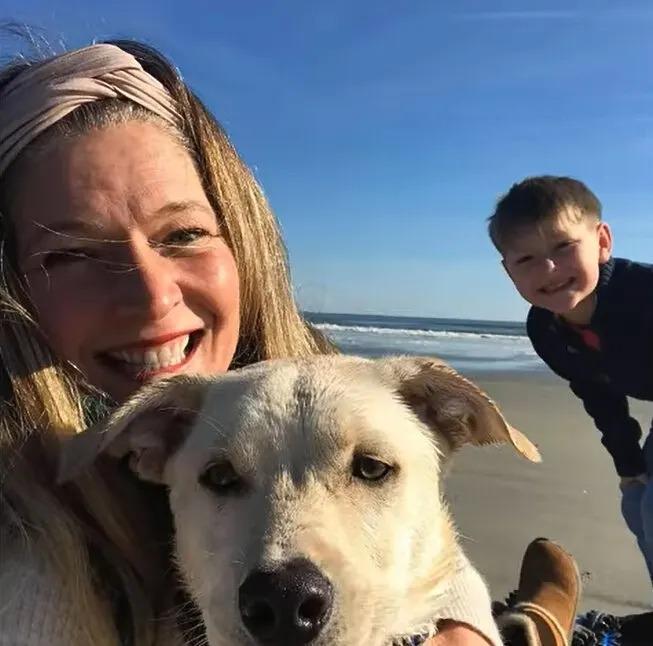 puppy and his family at the beach