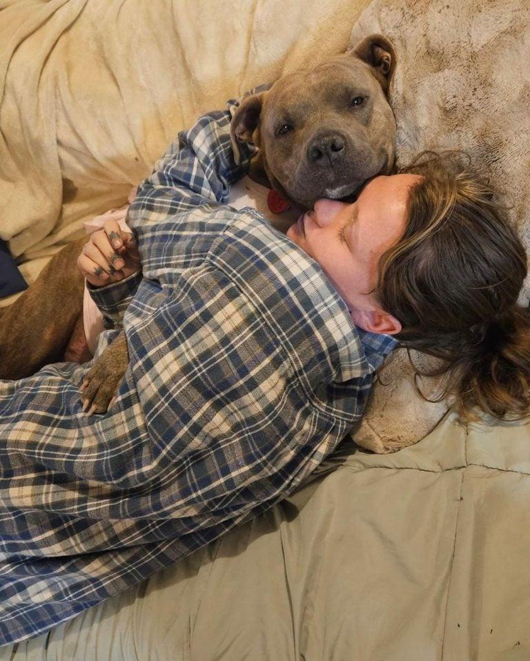 dog and woman cuddling