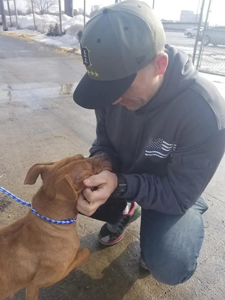 man and pit bull outside