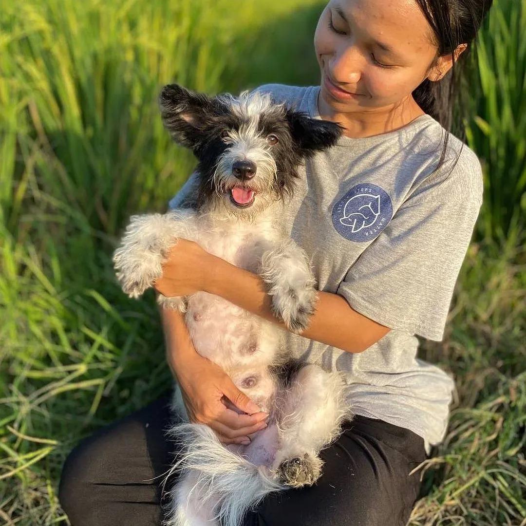 woman holding dog outside