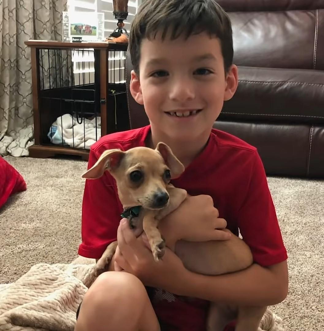 boy holding pup