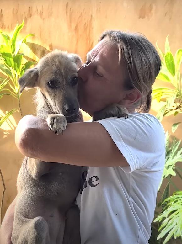 woman kissing dog