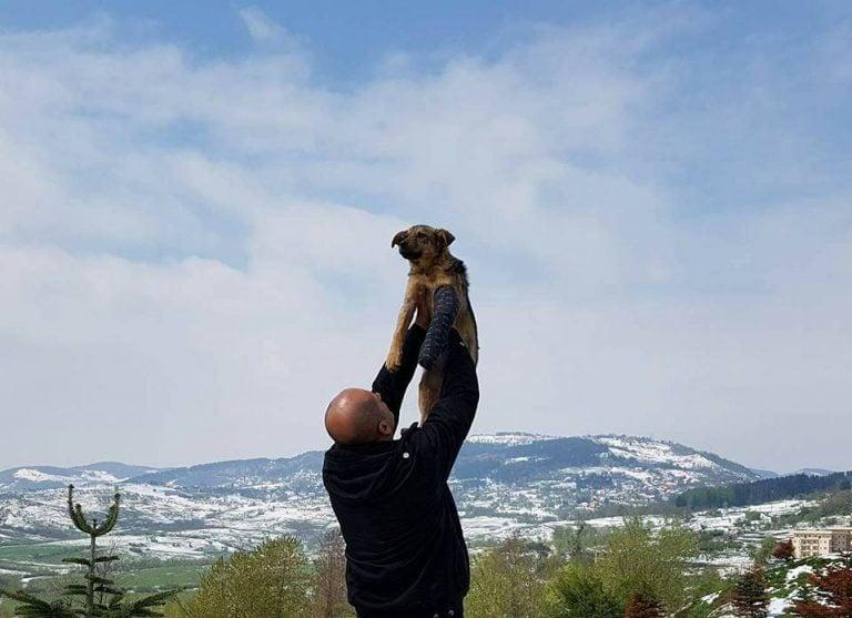 man holding dog up