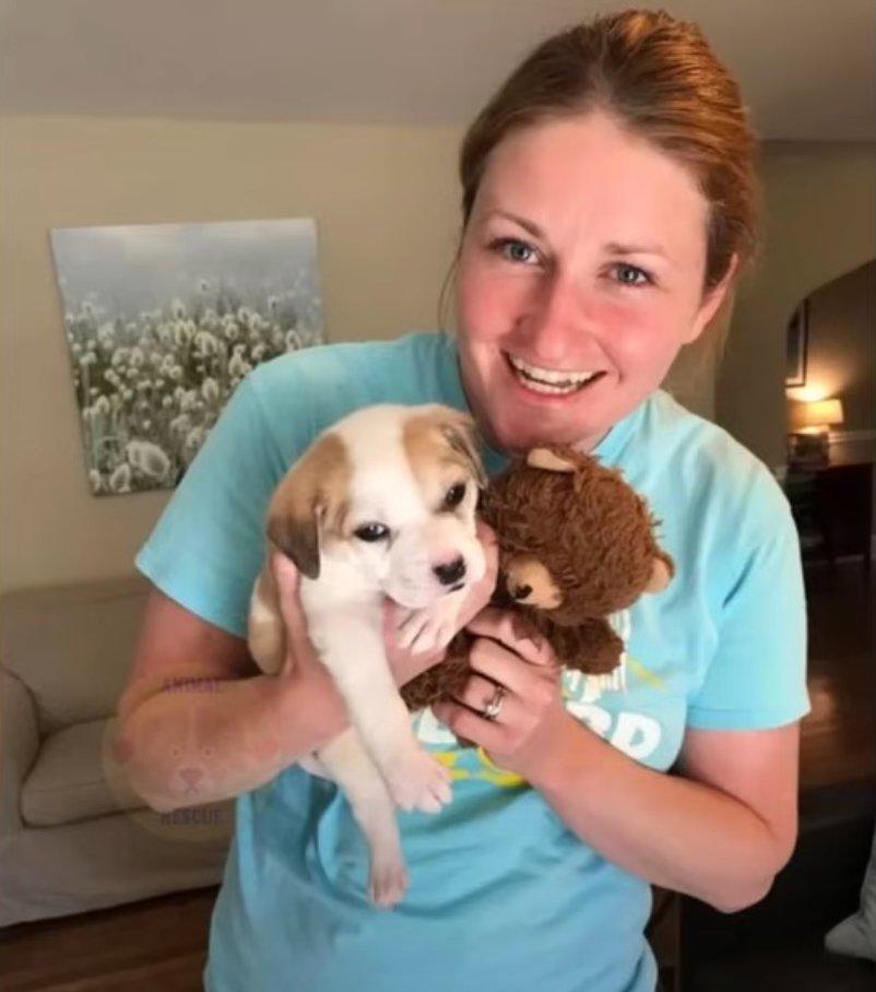 adopter carying her new pup