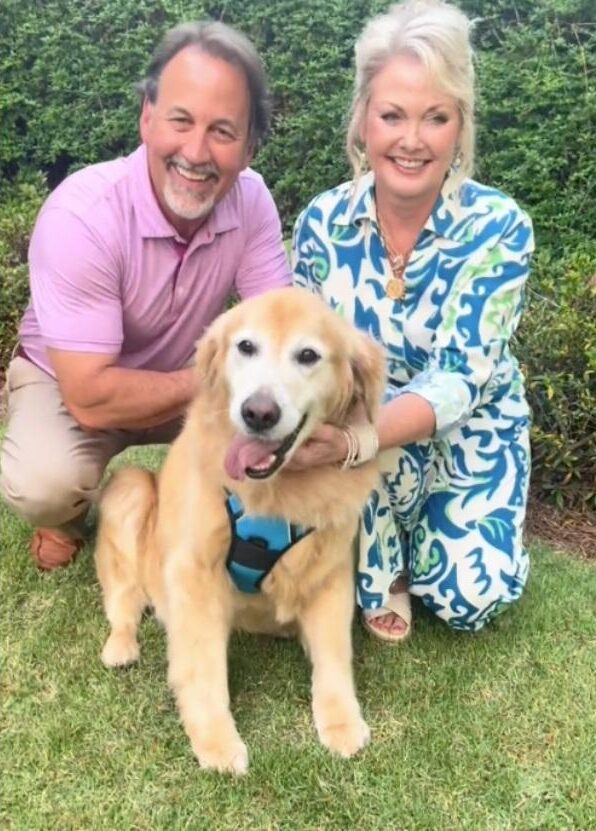 happy baylor taking a photo with his parents