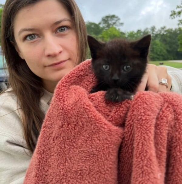 woman holding the rescued black cat